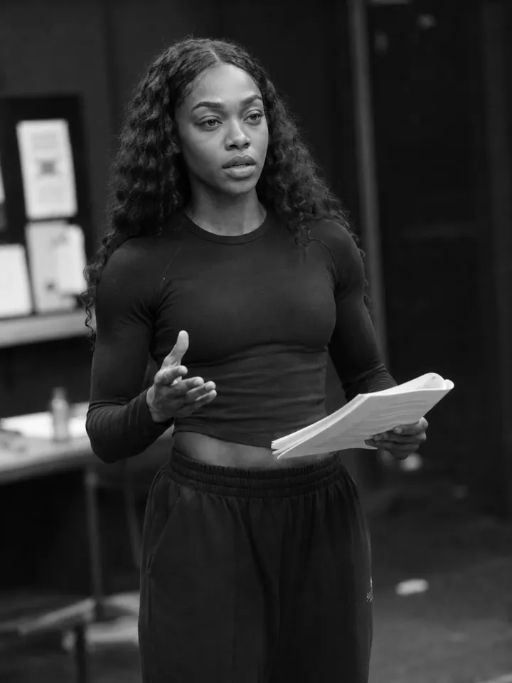 Actor in a rehearsal room holding a script